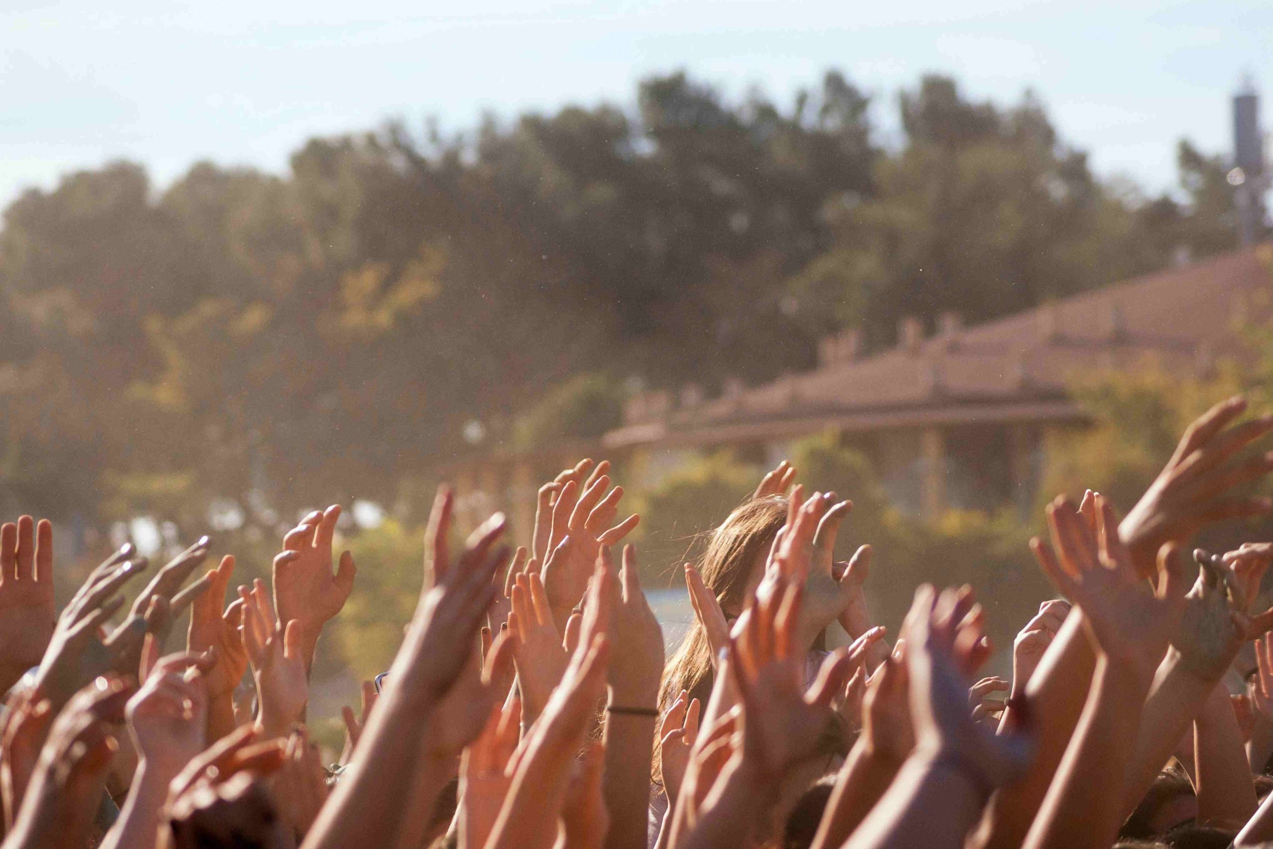 Concertgoers celebrate with hands up at Coachella