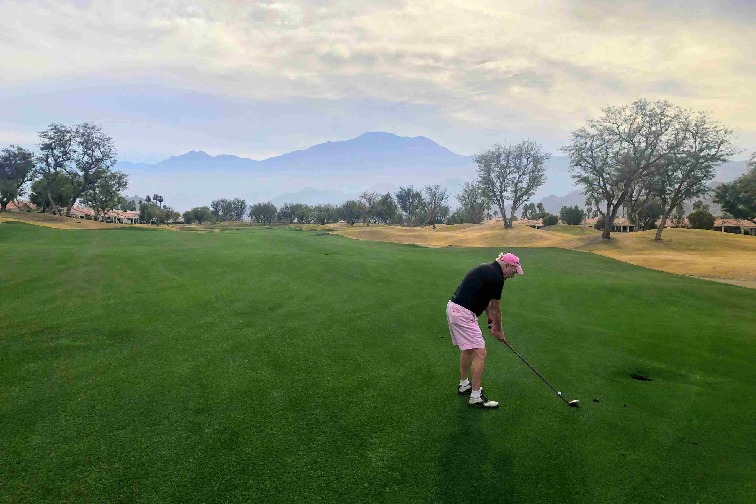 A man tees up on a La Quinta golf course